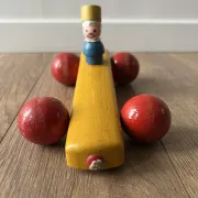 Vintage wooden pull toy, yellow car and small soldier.
