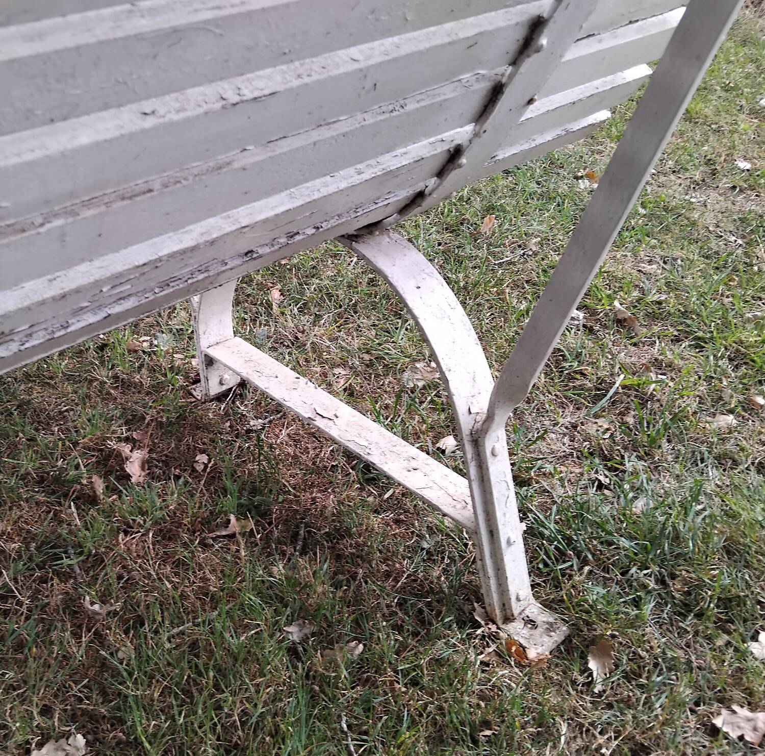 Old garden bench with metal legs and wooden slats