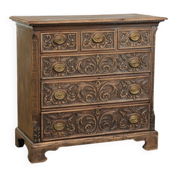 Richly carved English oak chest of drawers from the 18th century