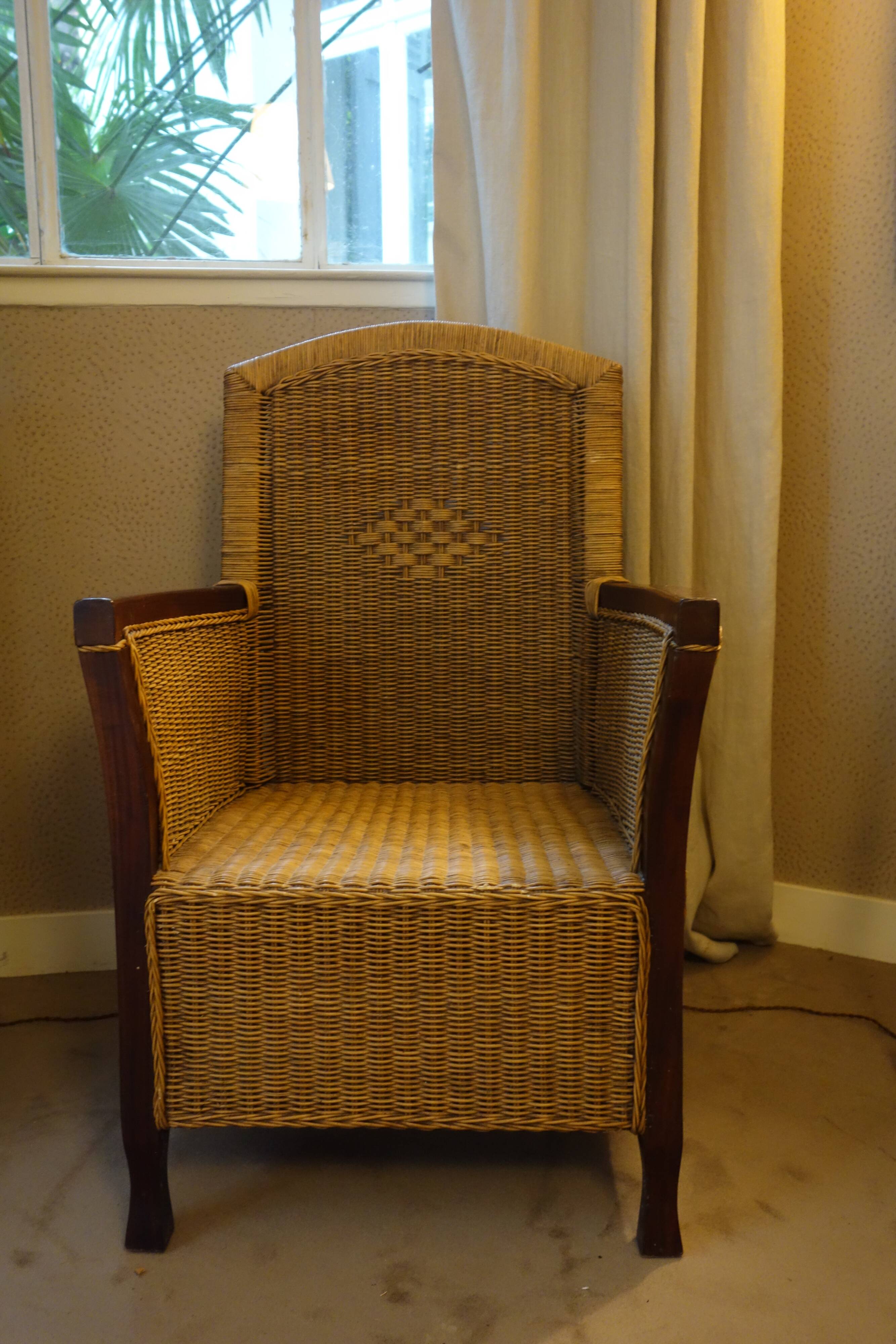 comfortable colonial-style armchair in rattan and mahogany