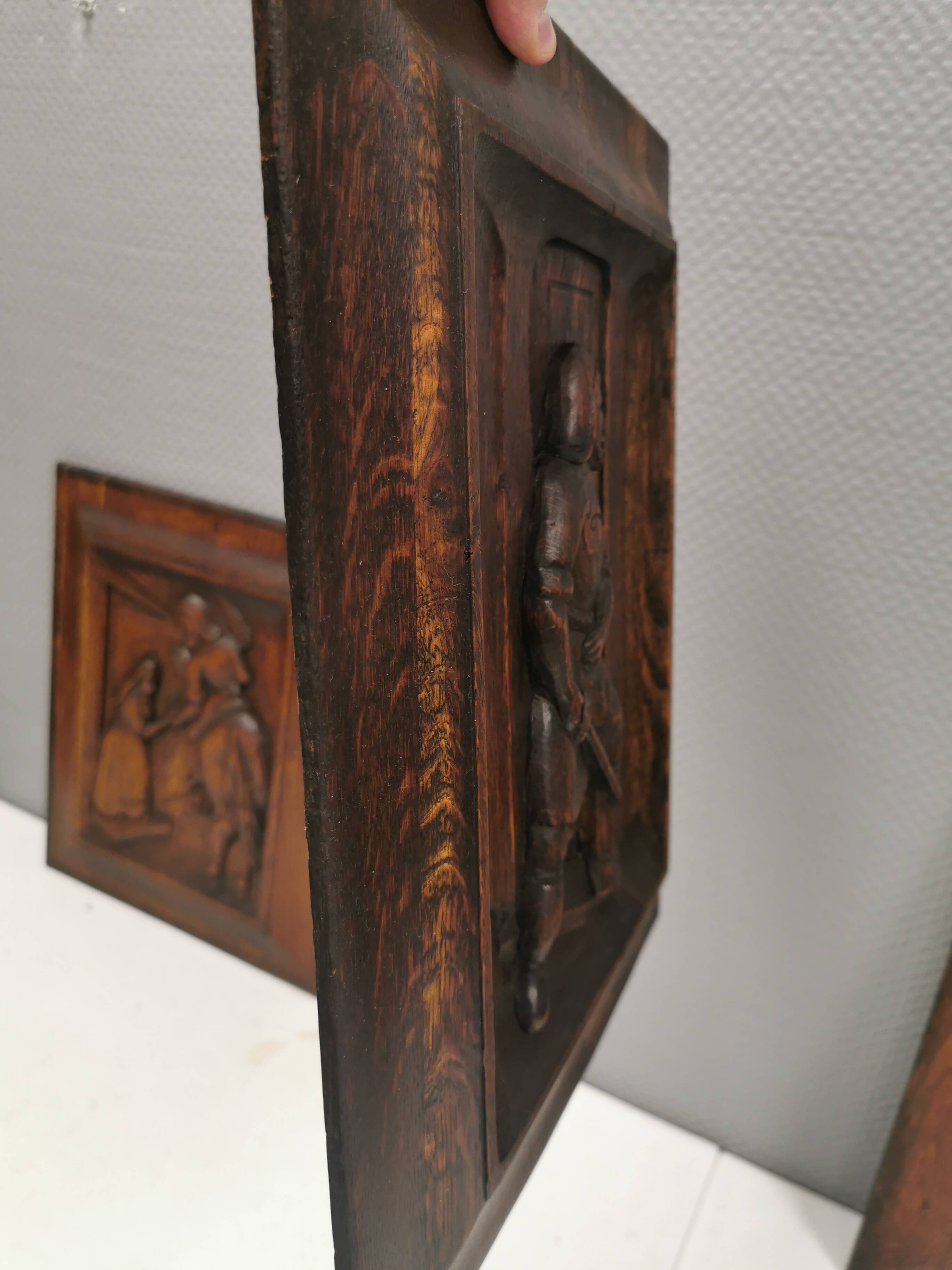 Four old wooden carvings to hang on the wall.