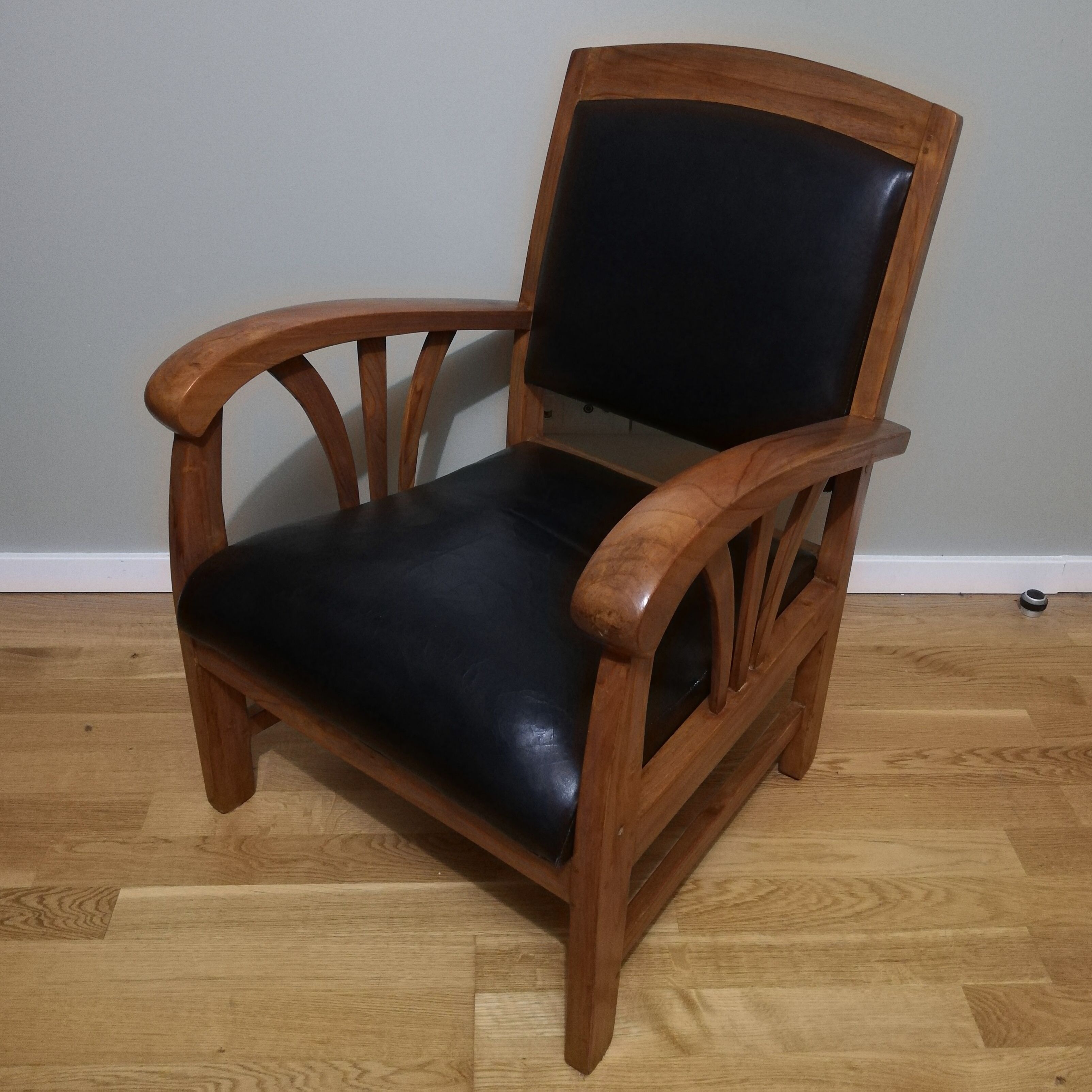 Colonial armchair in teak and black leather