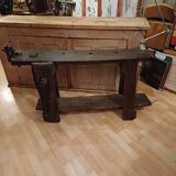 Small, very old, brutalist workbench equipped with a period workshop lamp
