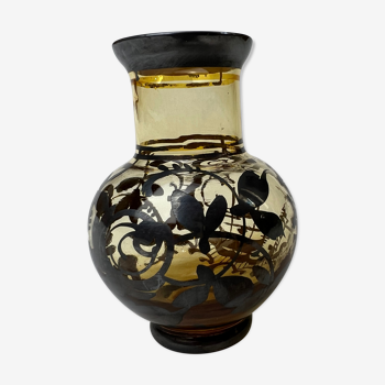 Vase with black flowers and tinted glass