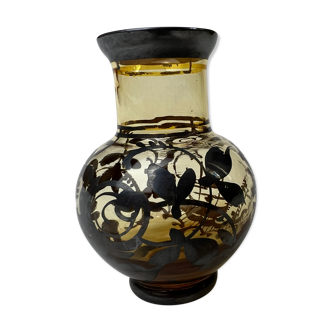 Vase with black flowers and tinted glass