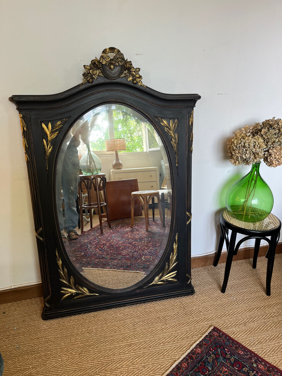 Large old trumeau mirror in black and gilded wood Napoleon style