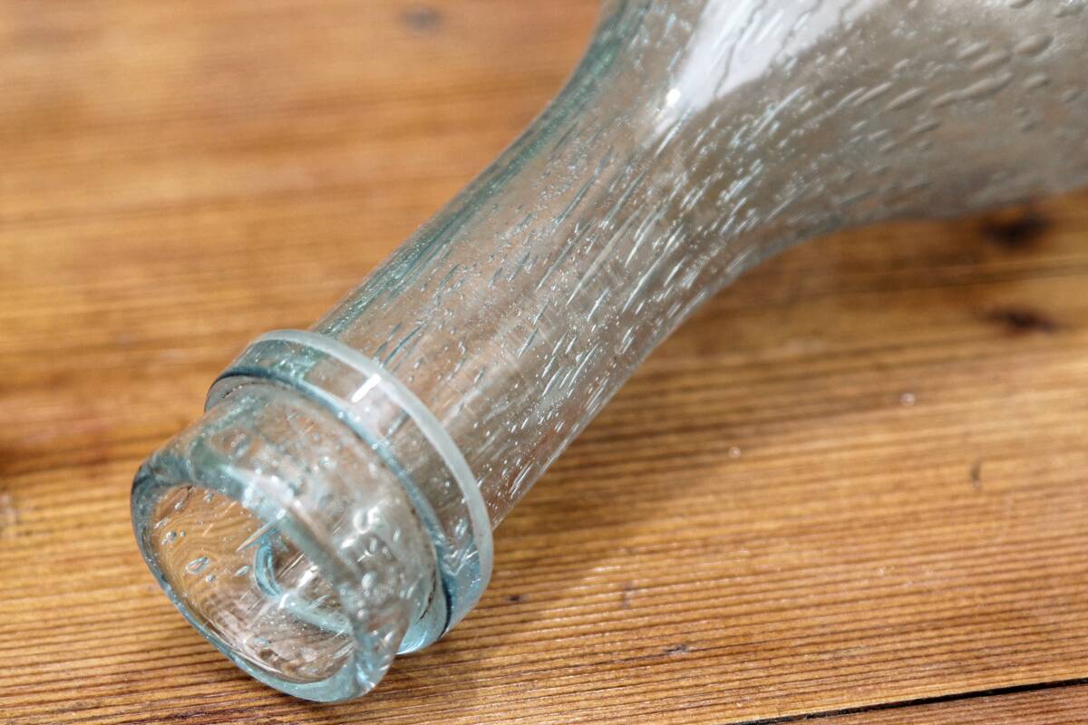 Biot blown glass bottle