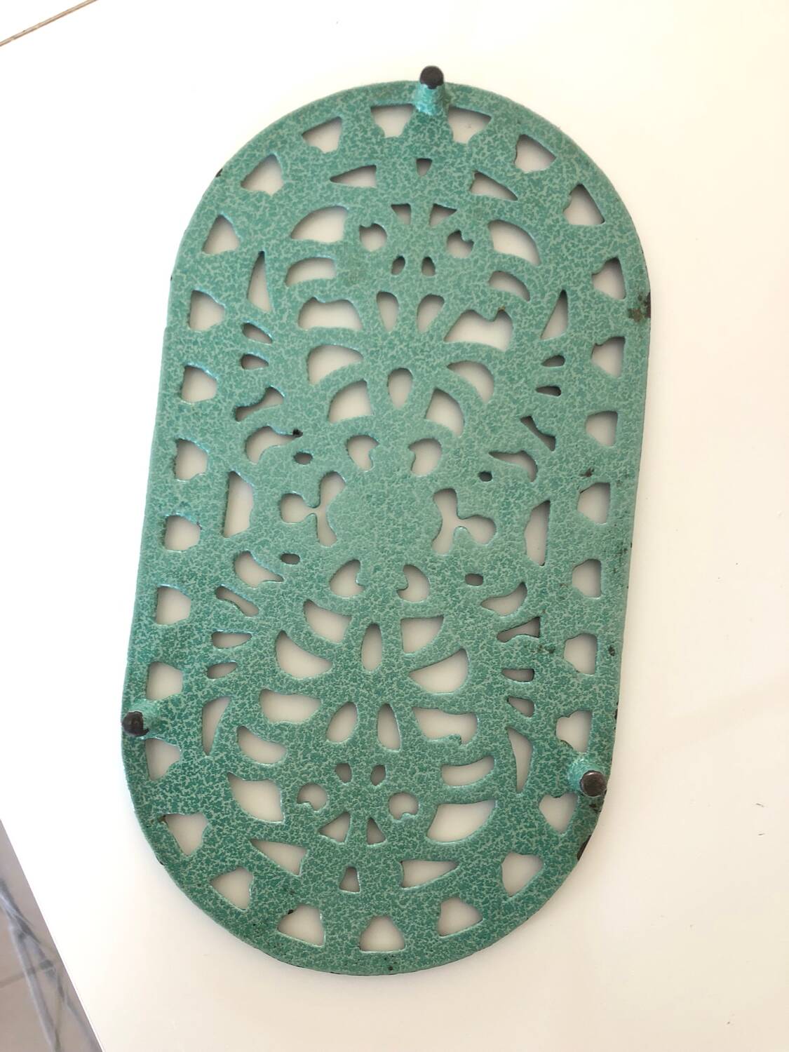 Oval trivet in green enameled cast iron