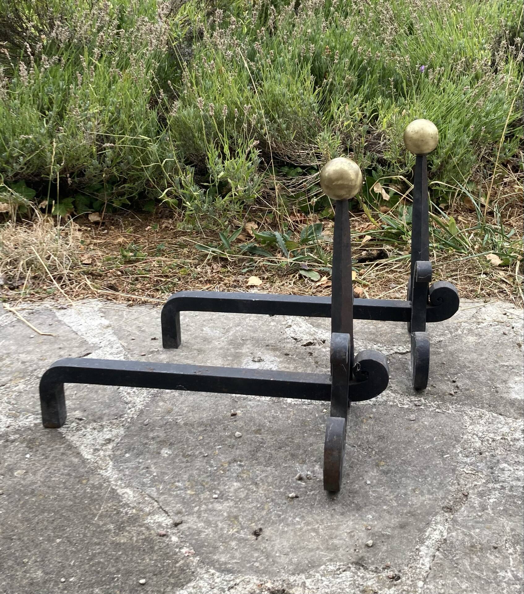 Massive wrought iron chenets from the 19th century topped with brass balls.
