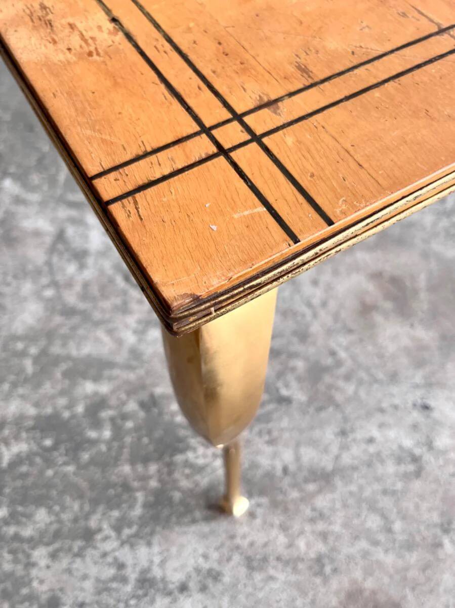 Vintage coffee table with gold-gilded legs and light brown wood veneer geometric inlaid top