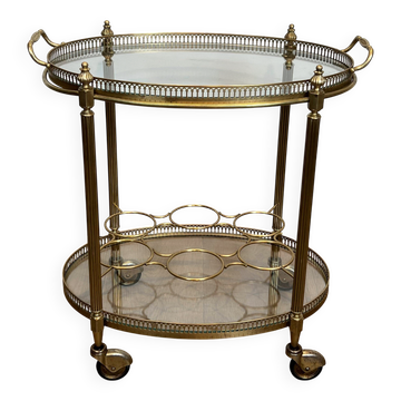 Oval brass rolling table in the style of Maison Jansen. Circa 1940.