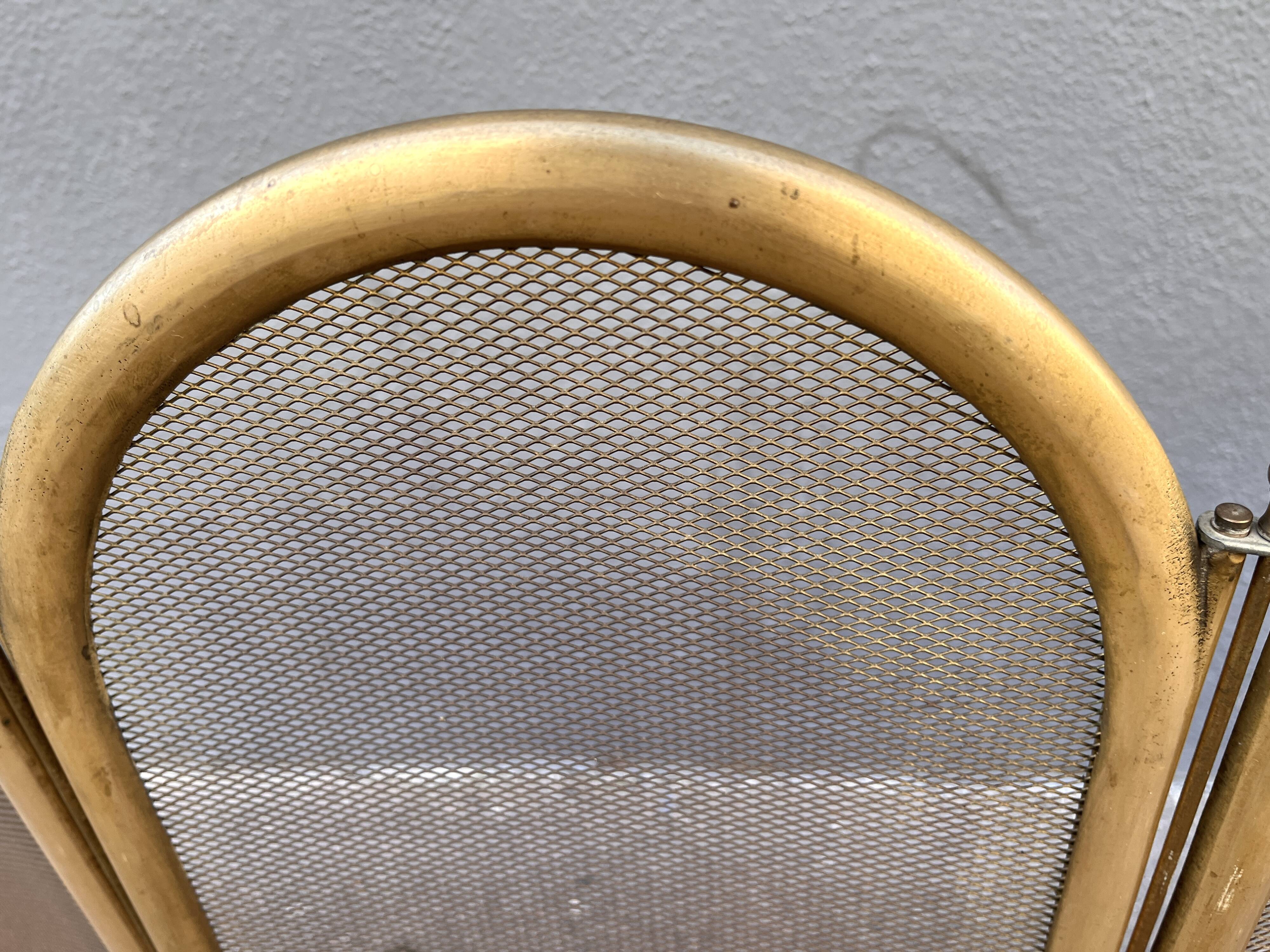 Antique brass fireplace screen from 1920, vintage spark guard.
