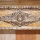 Antique fireplace from around 1880 in solid hand-carved elm with openwork columns.