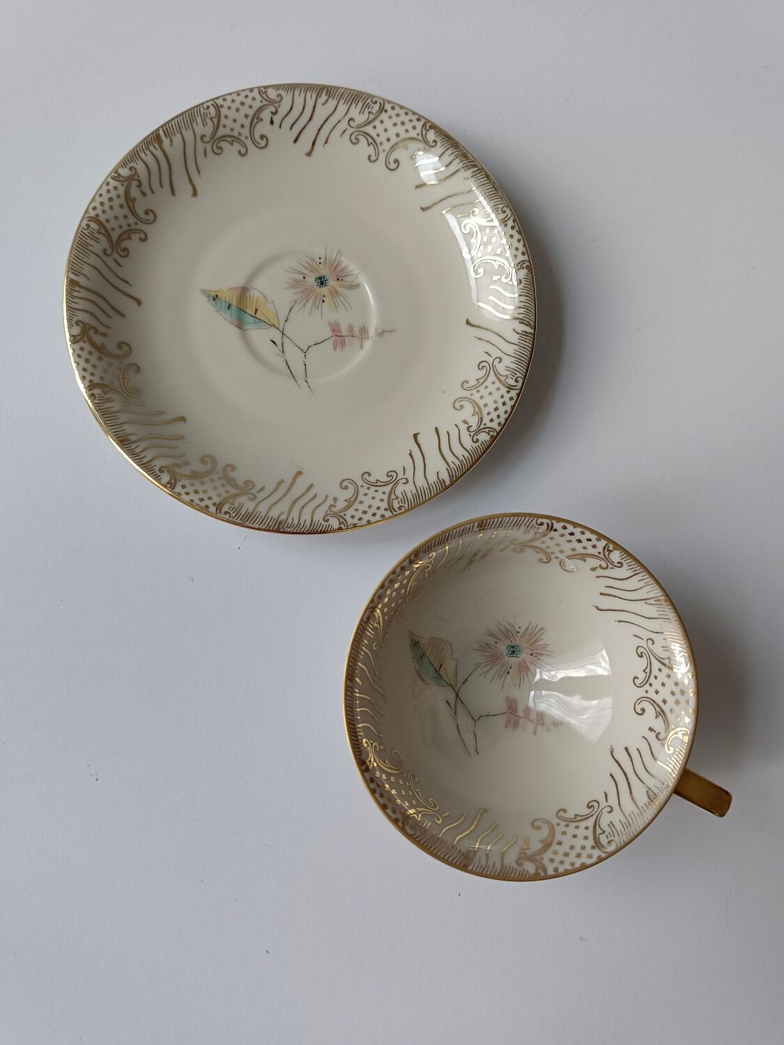 Set of mismatched fine porcelain cups signed with saucer