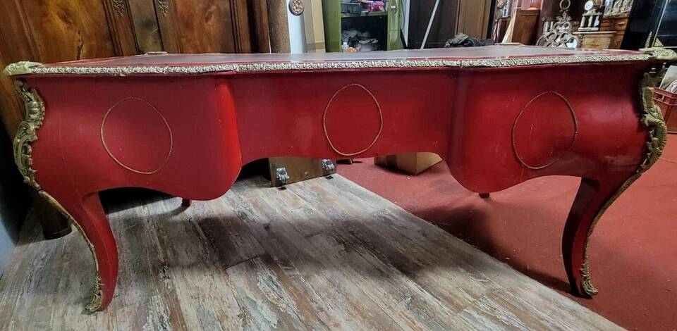 Louis XV style curved center desk in red lacquer and gilded bronze