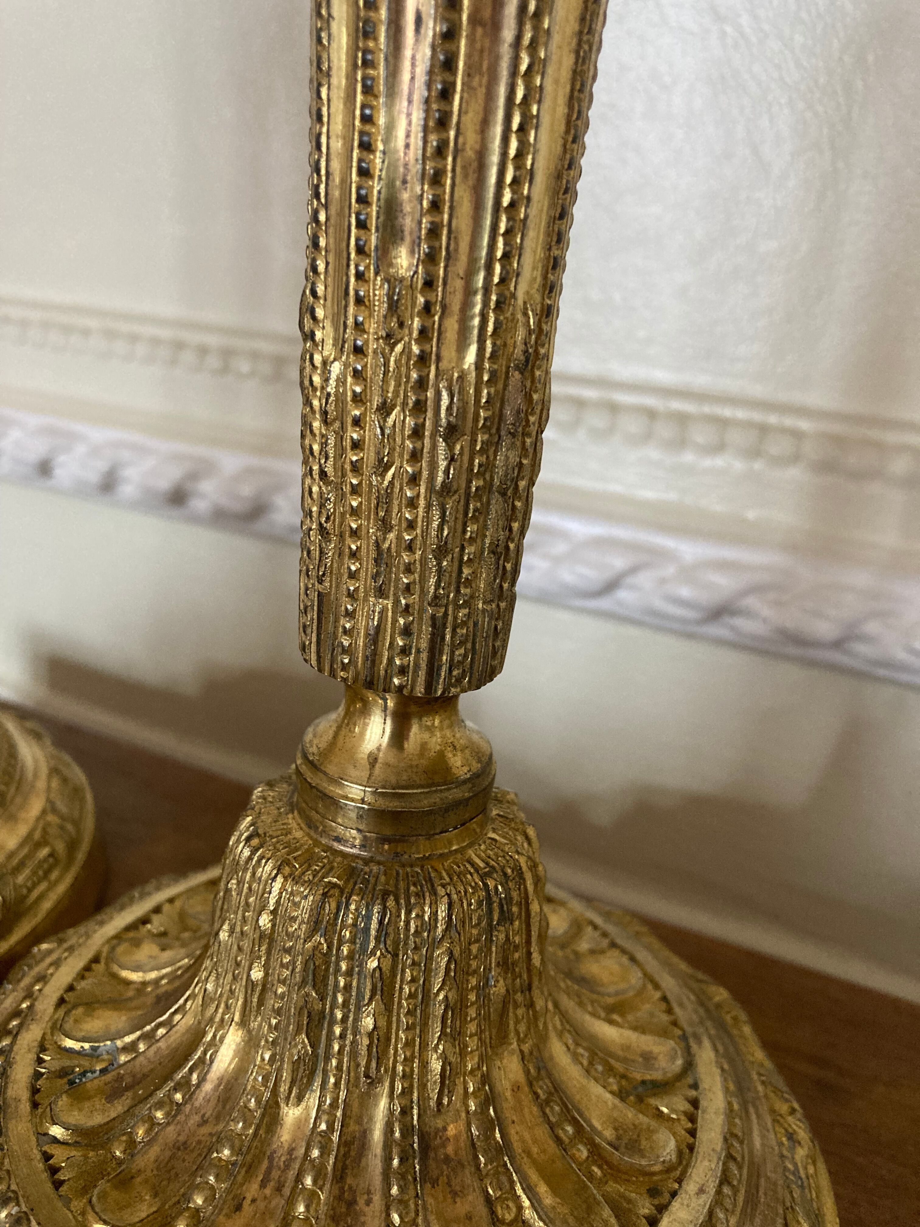 Pair of Louis XVI torch candlesticks in gilded bronze