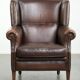 Subtle sheepskin wingback armchair with a deep cognac colour