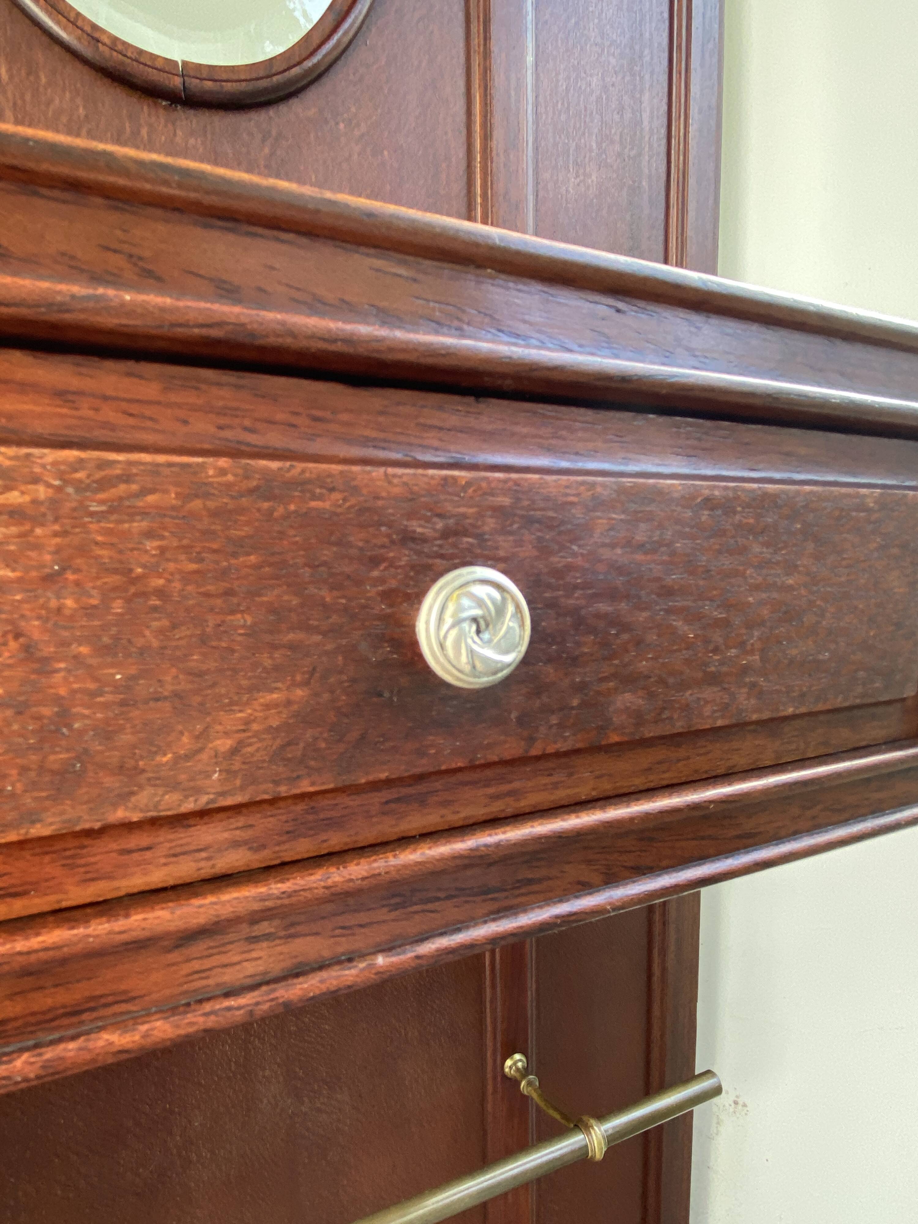Antique wooden coat rack with mirror and shelf.