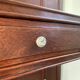 Antique wooden coat rack with mirror and shelf.