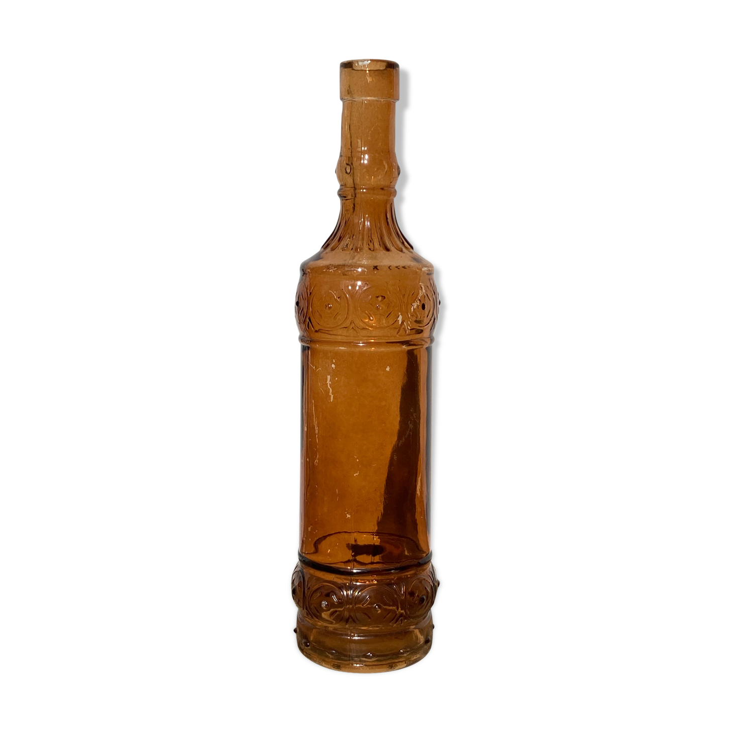 Vintage amber bottle in patterned brown glass