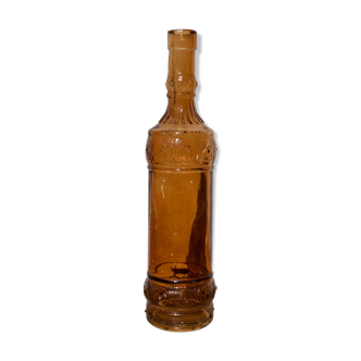 Vintage amber bottle in patterned brown glass