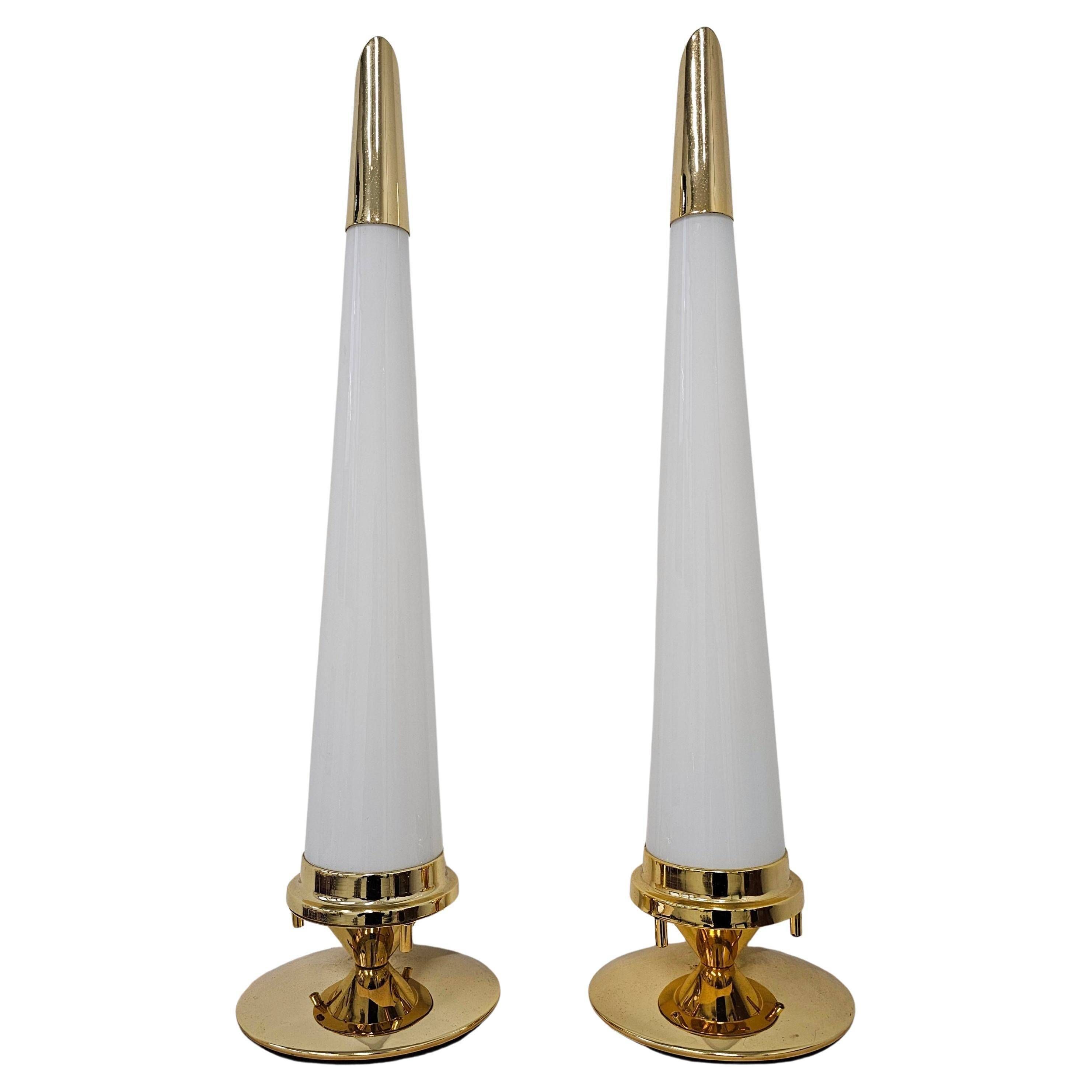 Pair of Hollywood Regency table lamps in brass with glass shades.