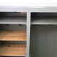 Curved wardrobe workshop locker made of wood repainted in grey.