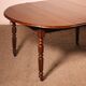 Extensible dining table from the early 19th century in walnut.