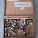 Wooden box containing 30 antique thimbles