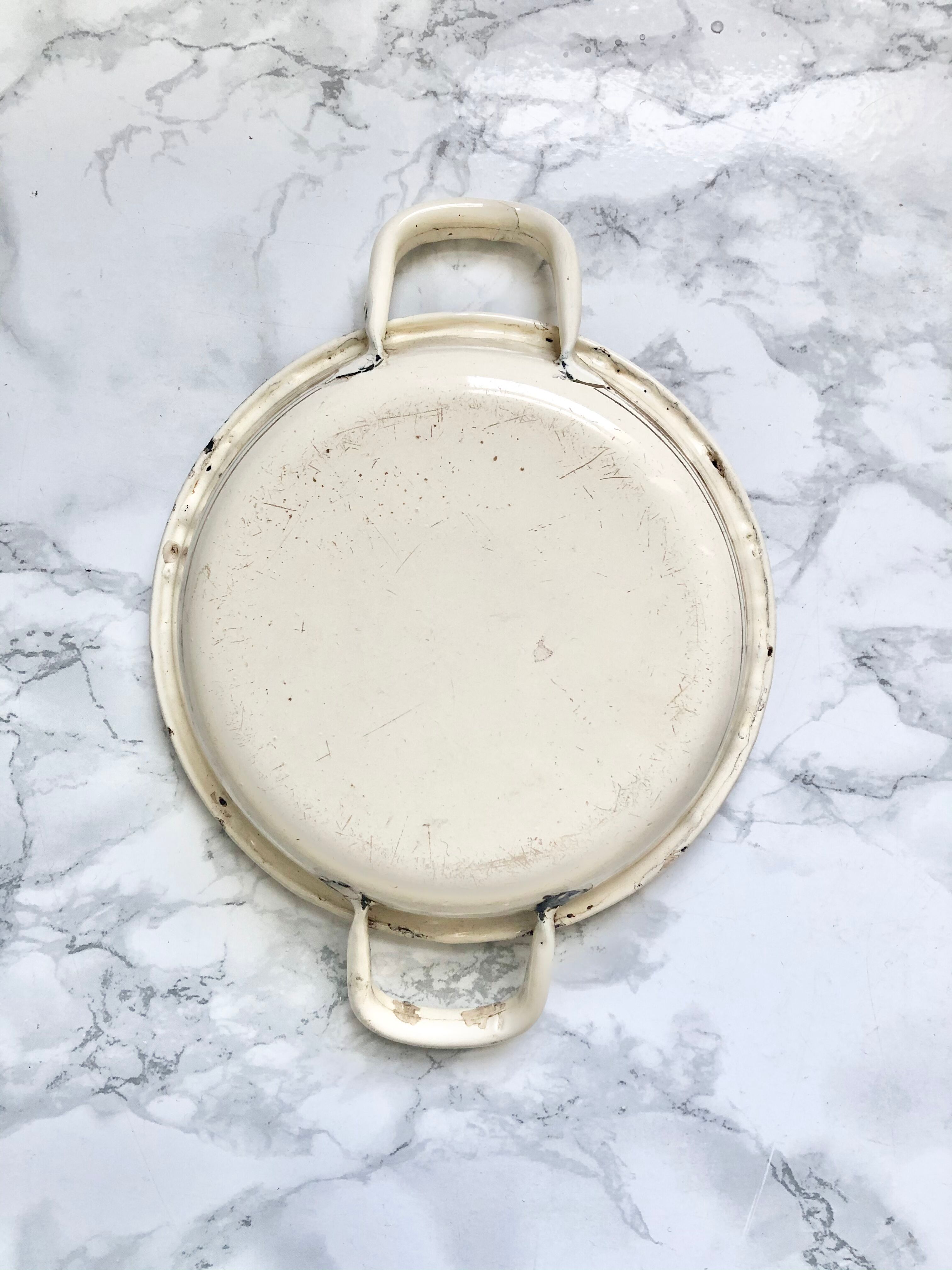 Old egg dish in creamy white and golden enamelled sheet