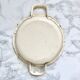 Old egg dish in creamy white and golden enamelled sheet