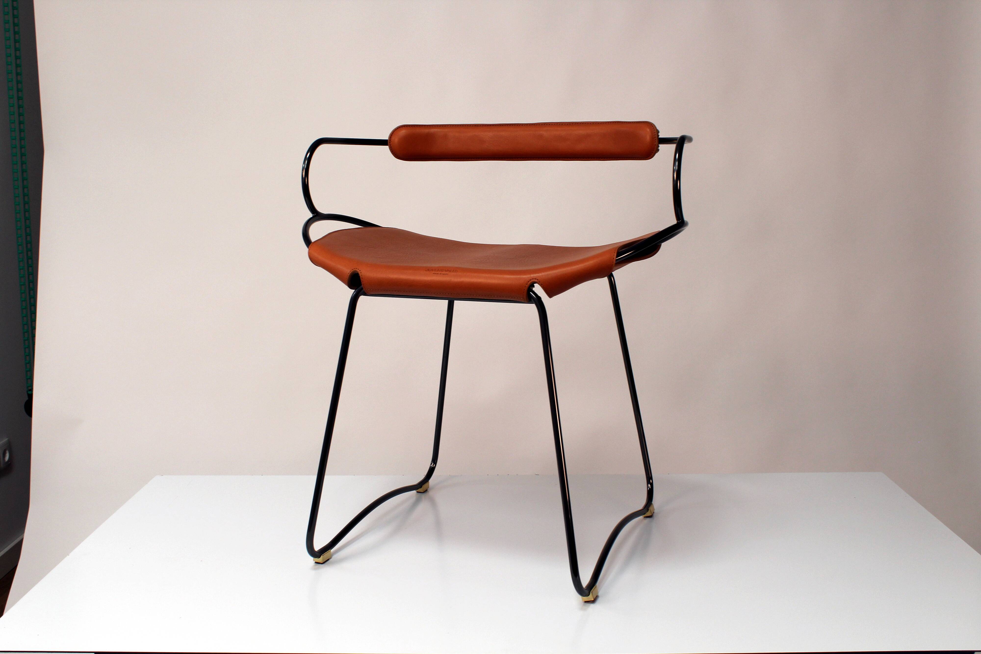 Table height stool with a backrest in aged silver metal and natural tan leather.