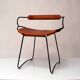 Table height stool with a backrest in aged silver metal and natural tan leather.