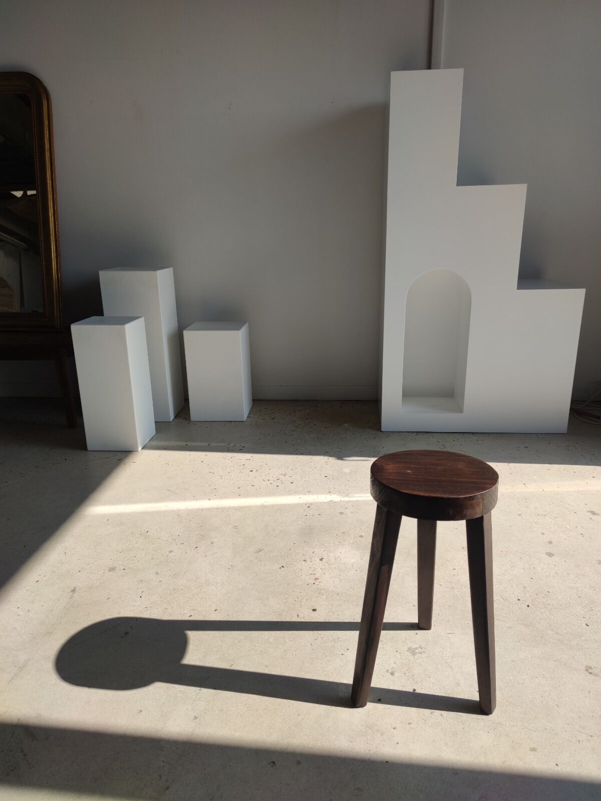 Small high tripod stool in brown solid wood