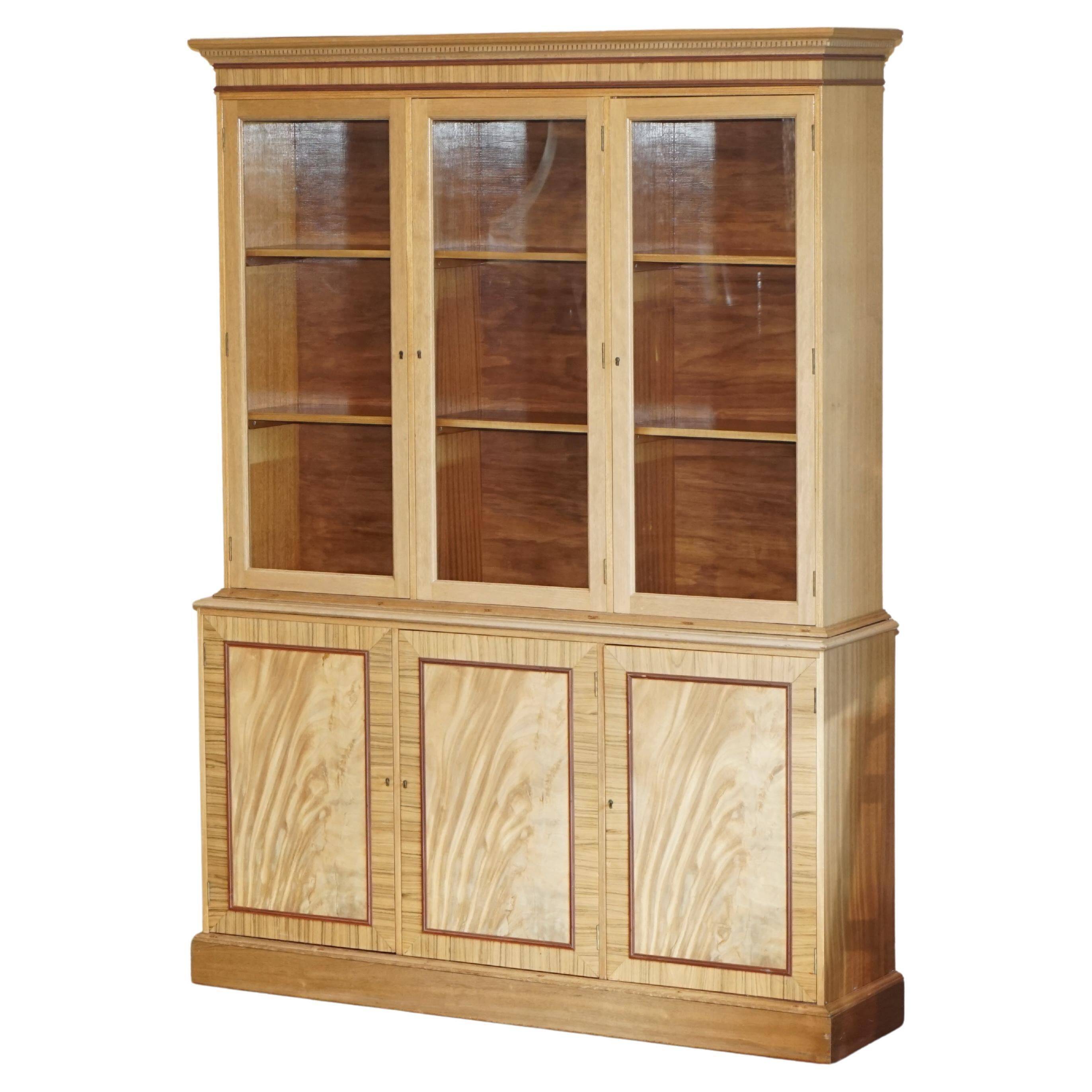 Library in the style of David Linley in satinwood, walnut, and rosewood.