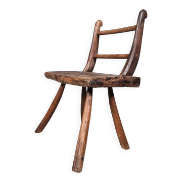 Rustic Wabi-Sabi style accent chair in dark curved hardwood, 1900s.
