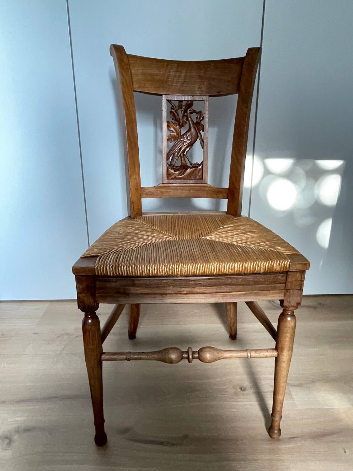 19th century straw chair with carved peacock back