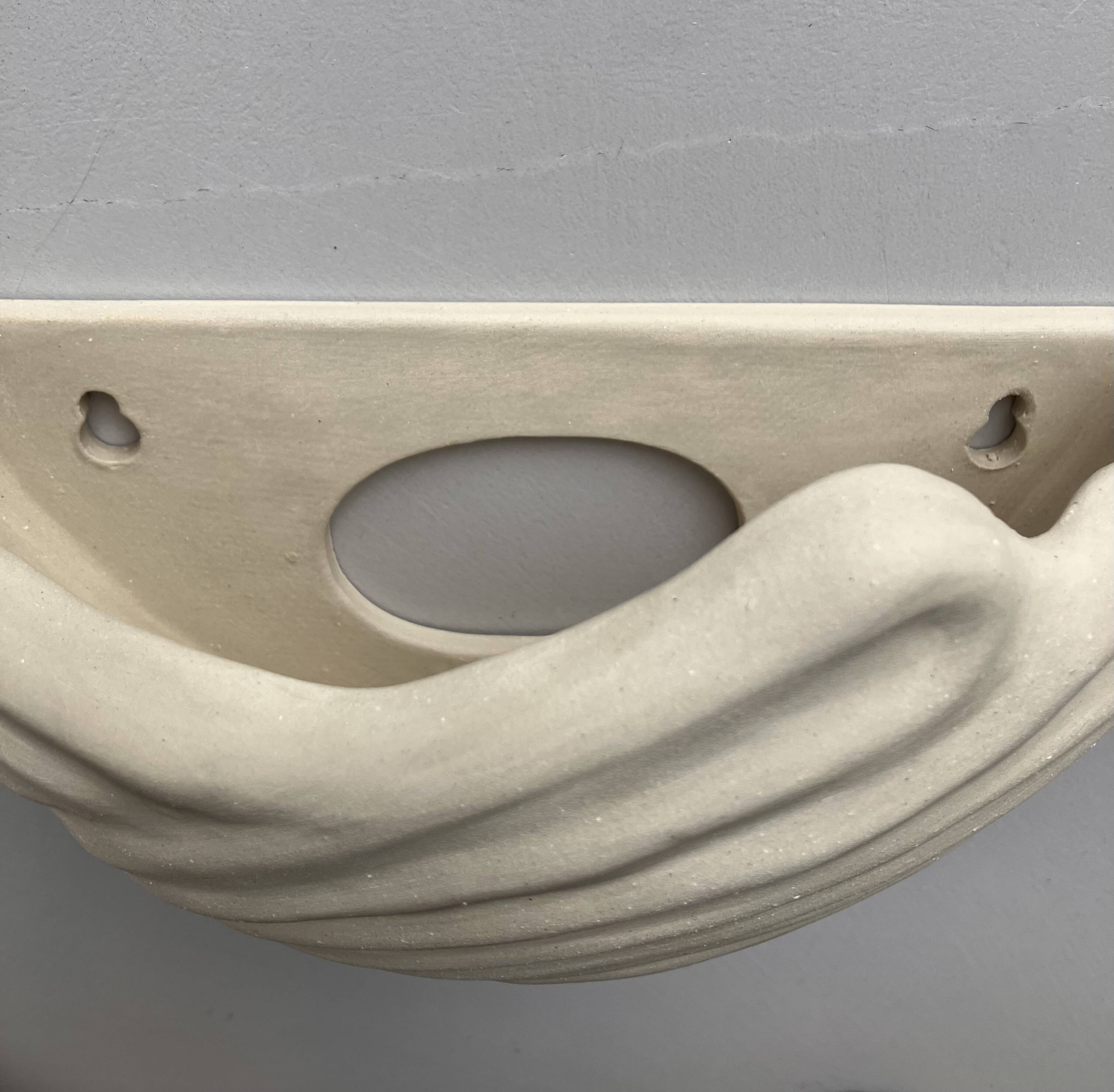 Shell-shaped ceramic applique handcrafted.