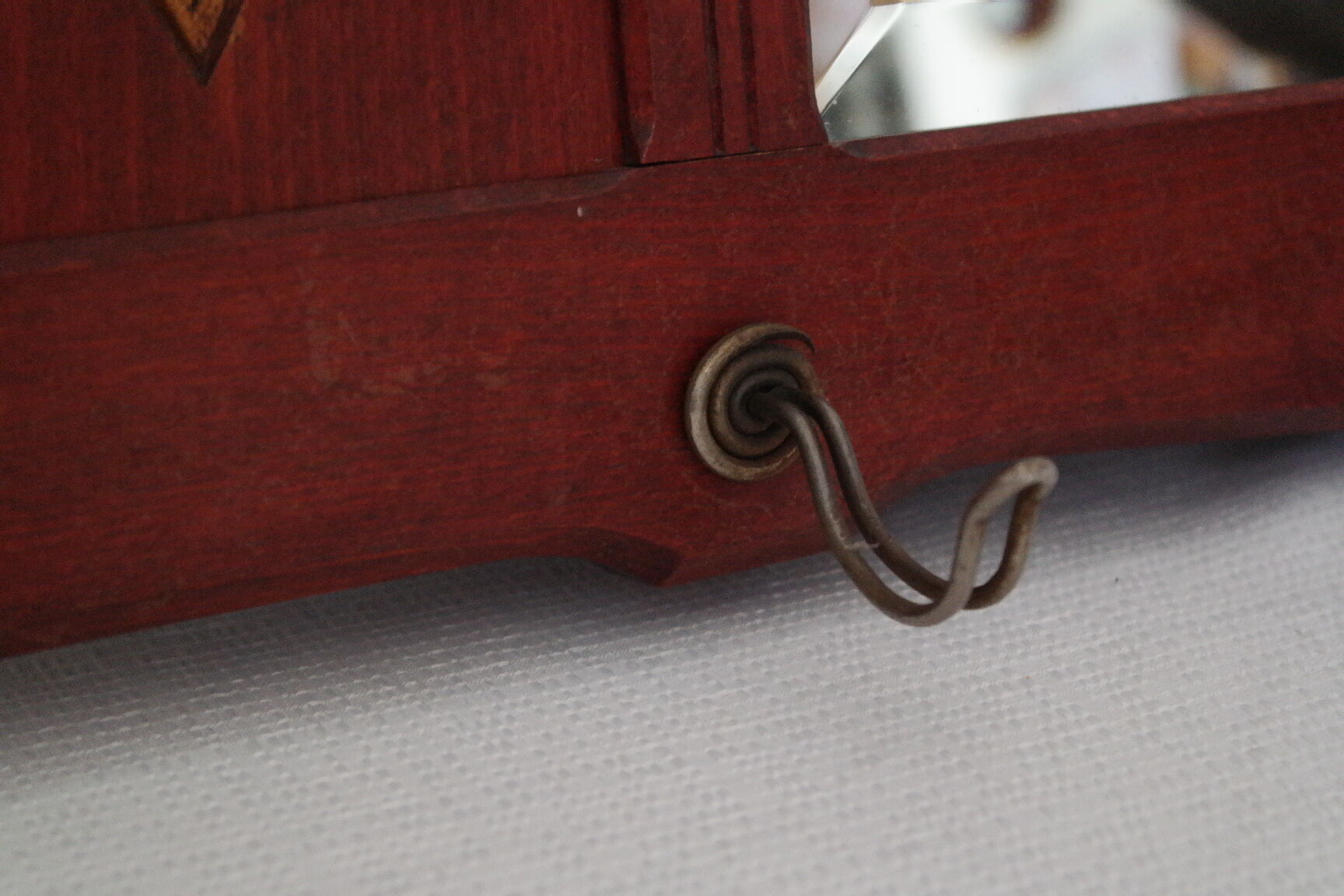 Red wooden wall-mounted coat rack and Art Deco mirror