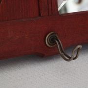 Red wooden wall-mounted coat rack and Art Deco mirror