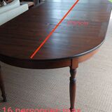 Round pine table with three extensions.
