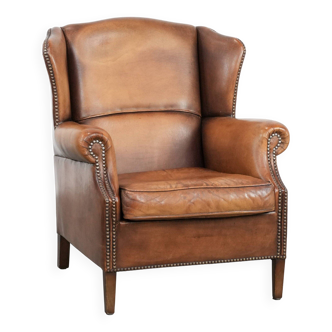Charming sheepskin leather wingback chair with warm colours