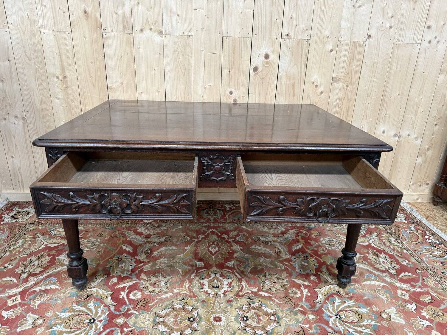 Middle table in a sculpted Louis XIII style living room.
