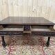 Middle table in a sculpted Louis XIII style living room.