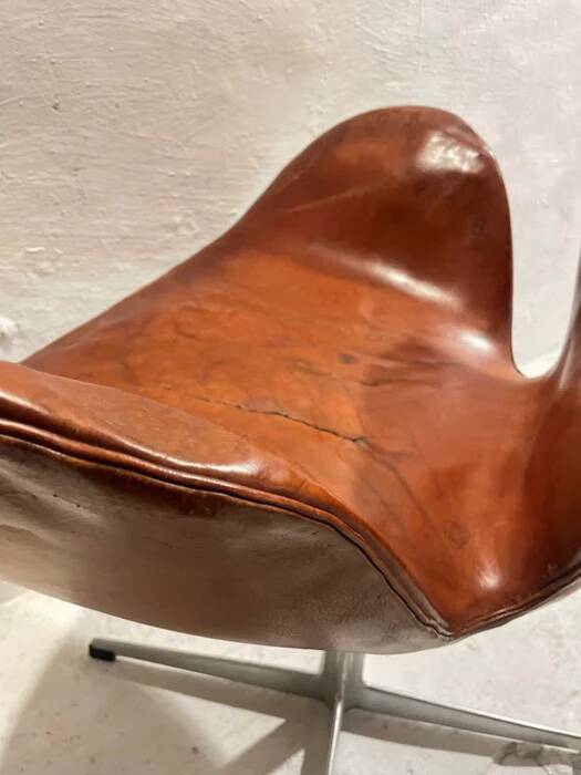 First edition Arne Jacobsen Swan chair, original patinated leather, 1950s