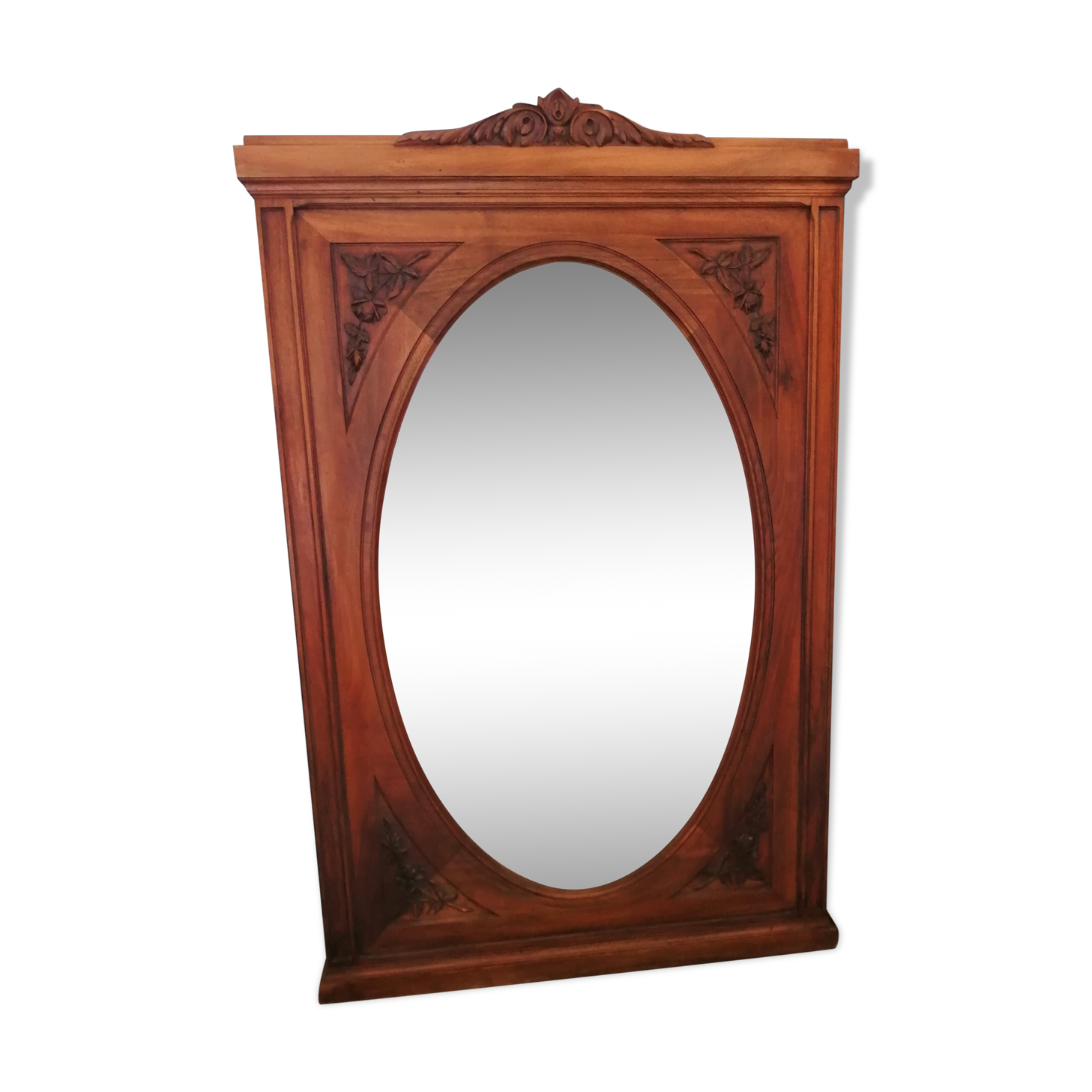 Old oval walnut wood mirror has flower carvings decoration