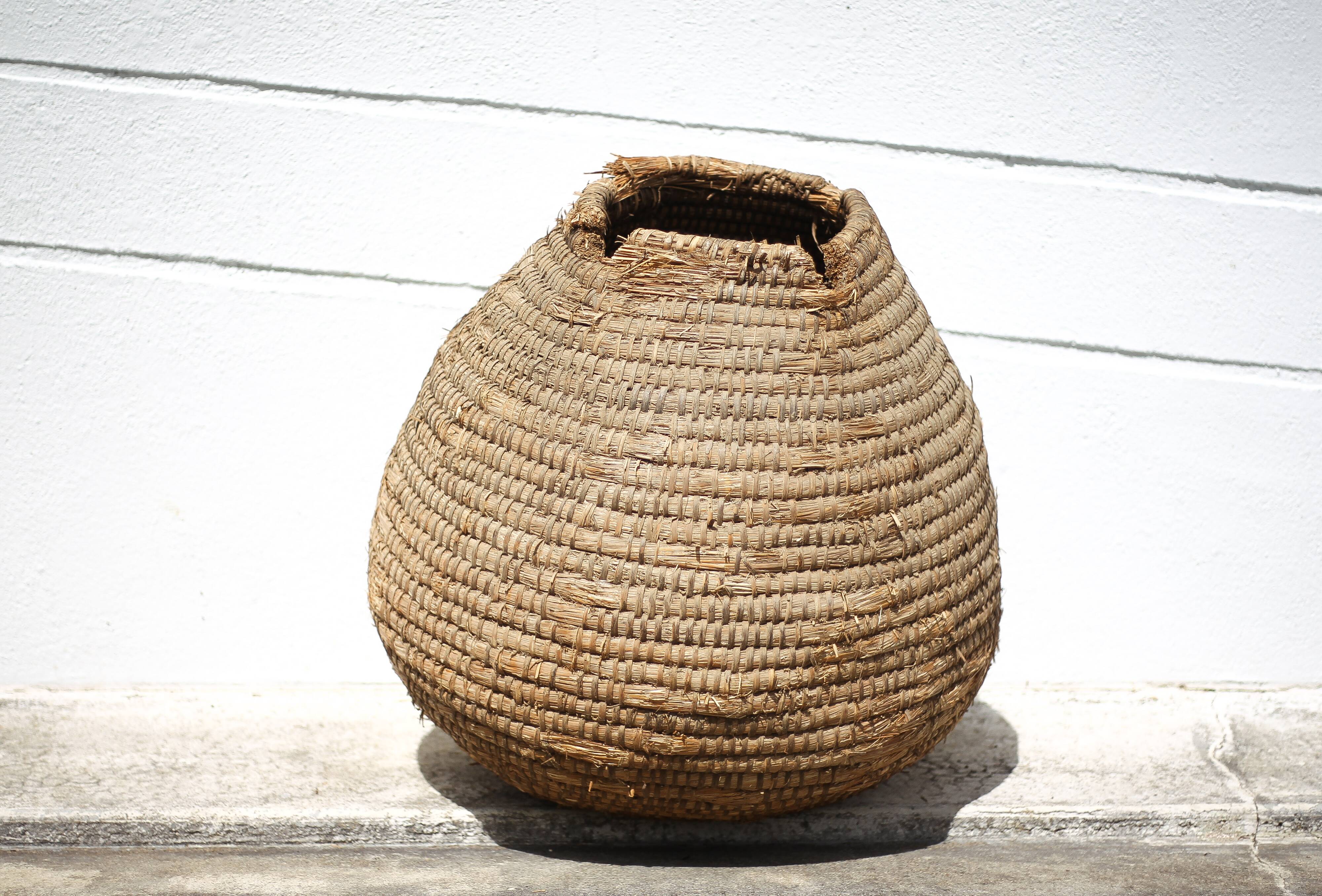Old basket, burgundy straw and bramble, woven basket, interior decoration, pantry, flowerpot