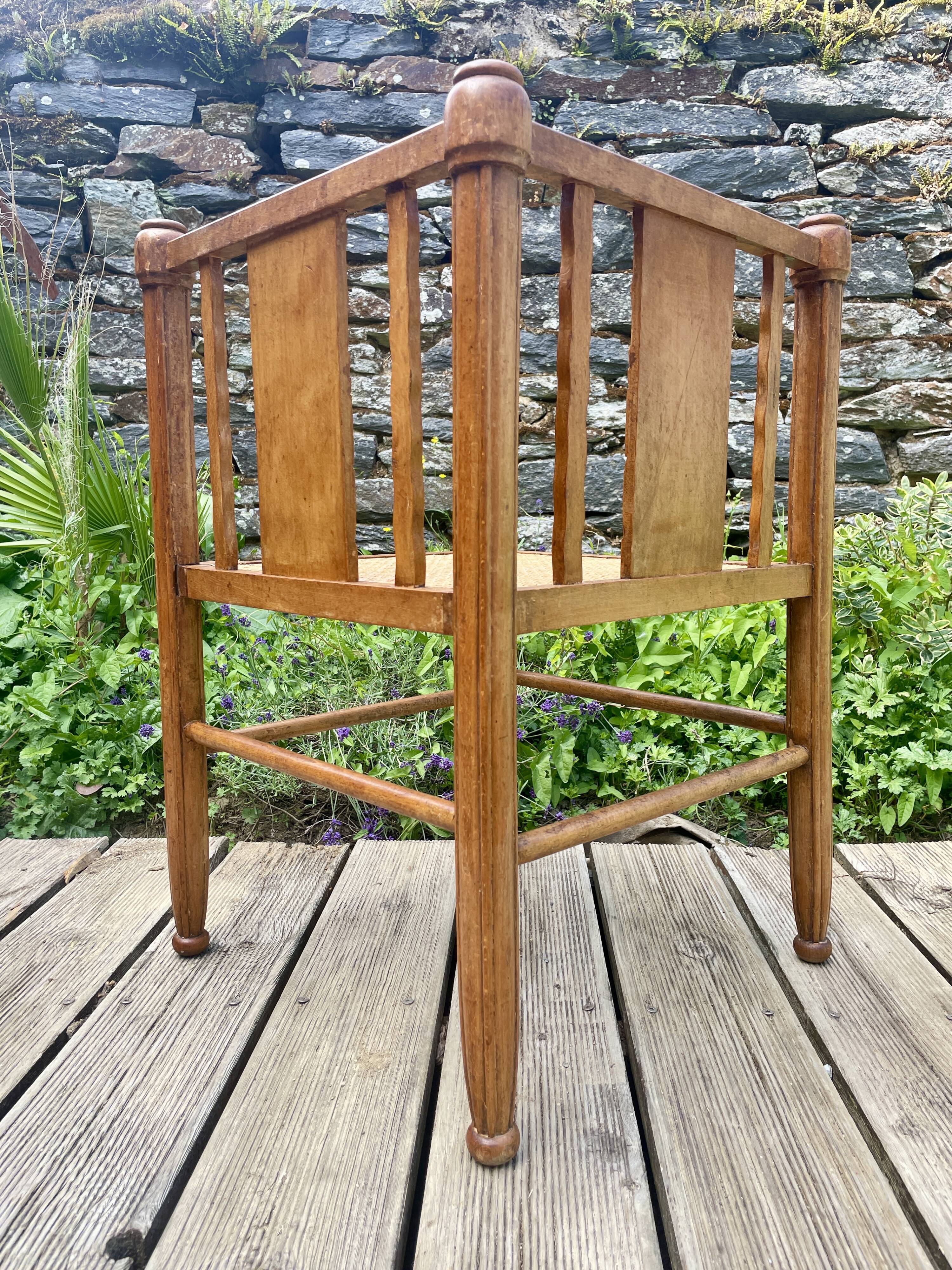 Art Deco corner chair with caning