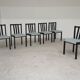 Set of 6 modernist black chairs with light blue-green ribbed fabric.