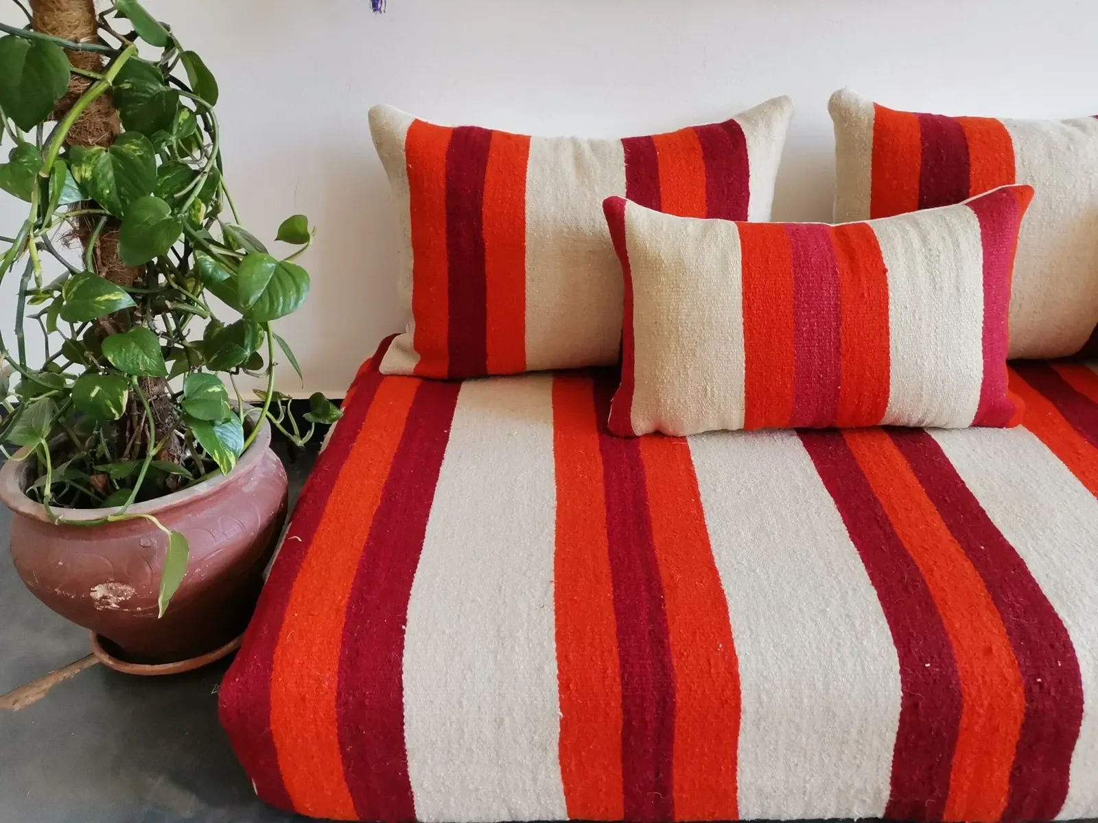 Set of covers for cream and red Moroccan floor sofa.